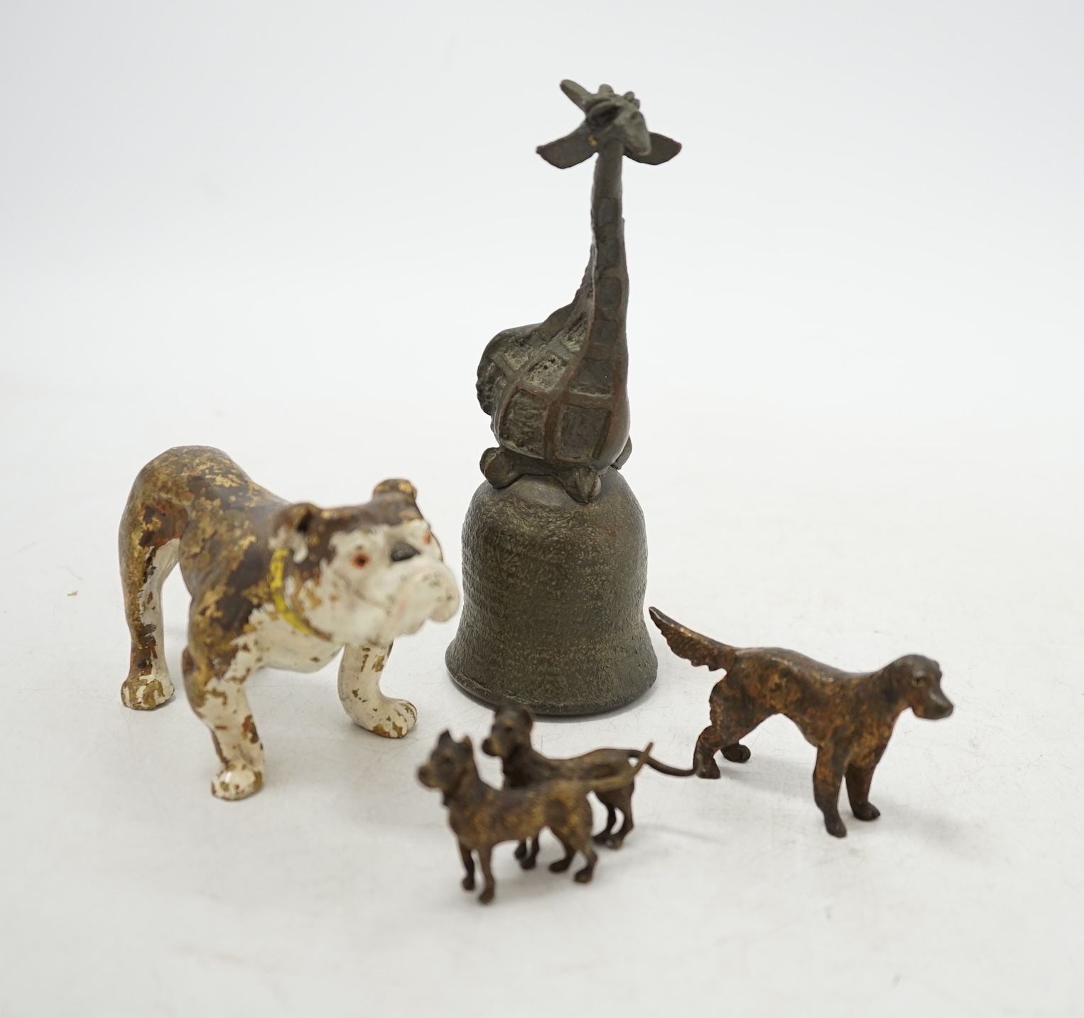 Three cold painted bronze dogs and a bronze giraffe handled bell, bell 13.5cm high. Condition - fair